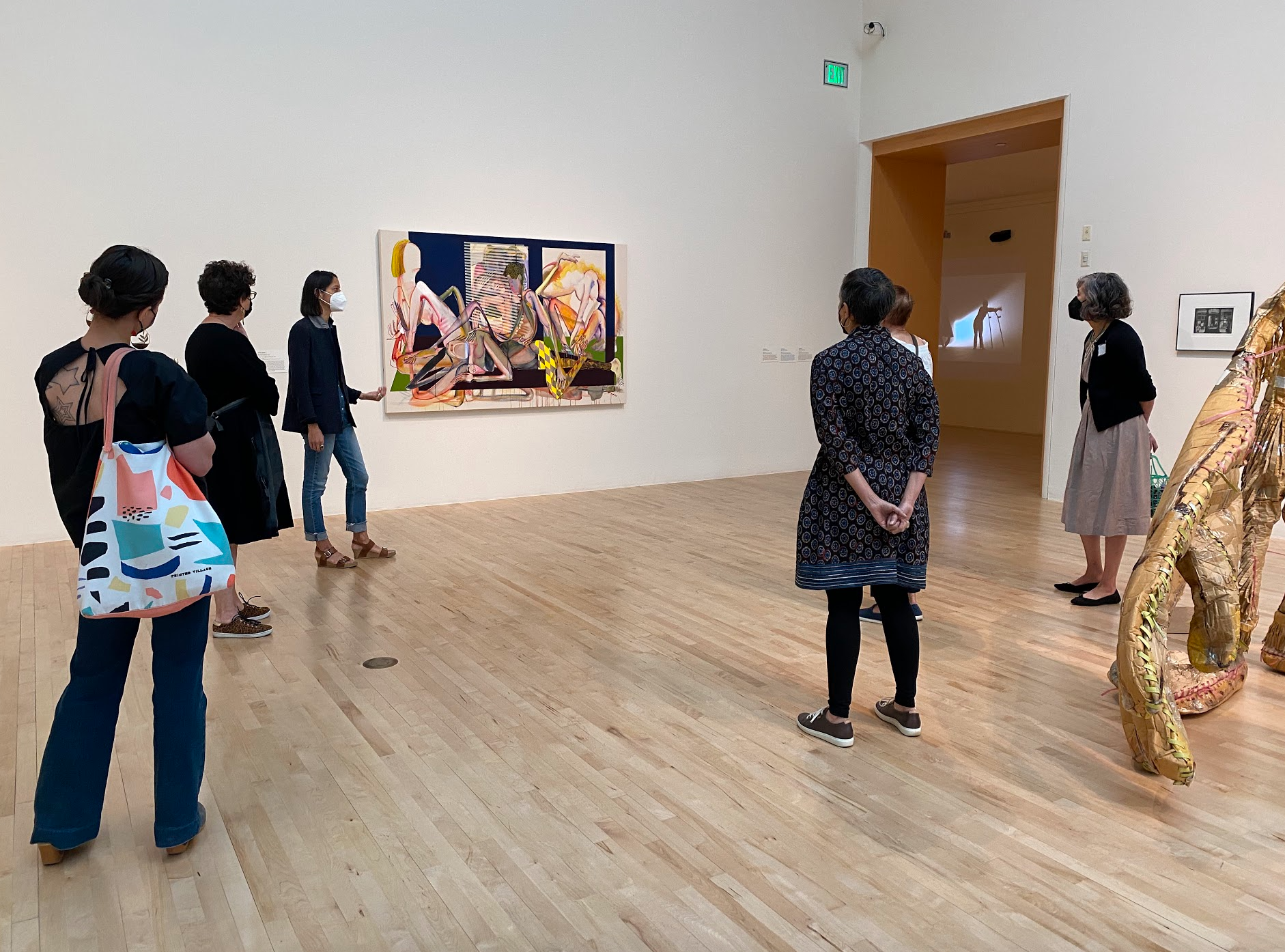 A group of women look at a painting in a museum