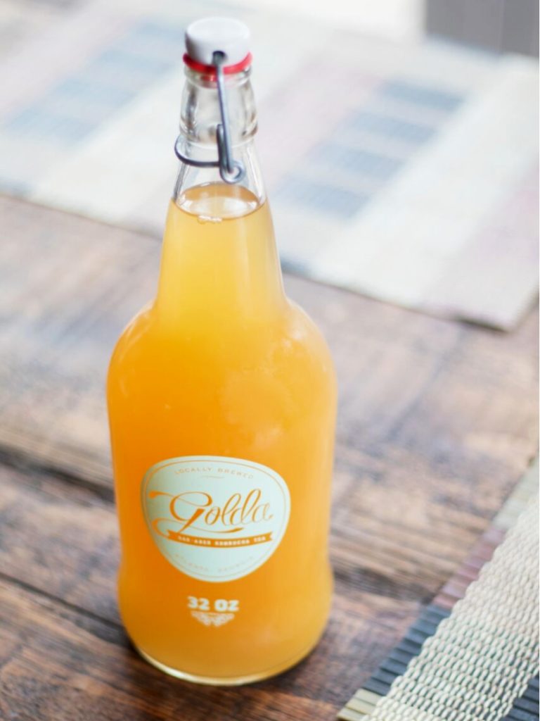 Glass bottle with a yellow orange drink