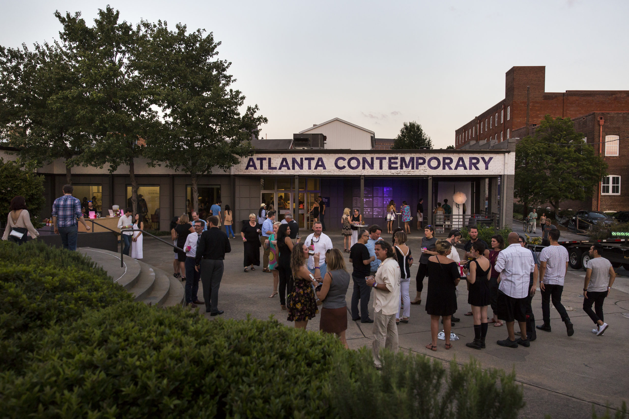Exterior shot of Atlanta Contemporary with a crowd gathered, mingling